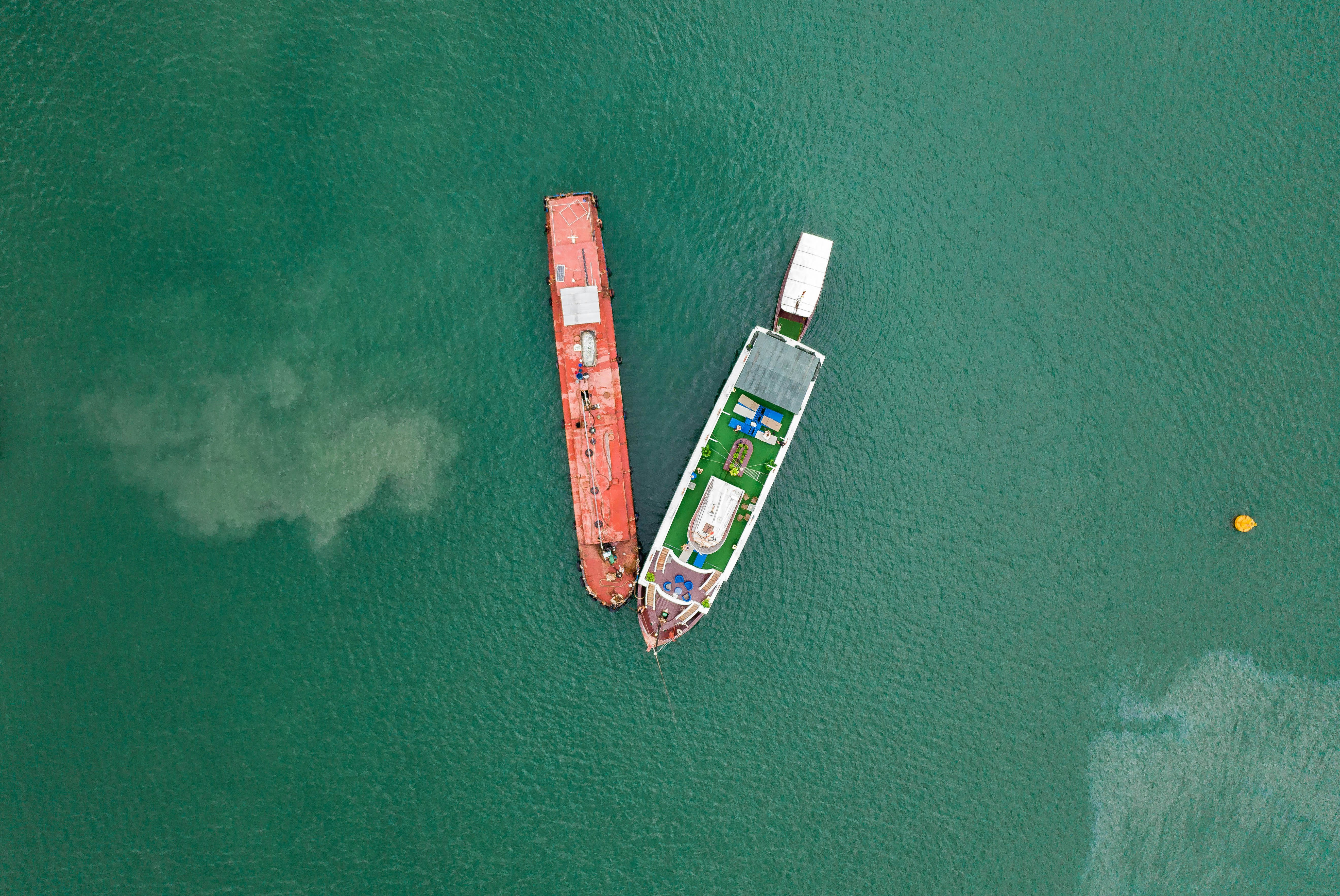 aerial photography of two boats on green sea during daytime